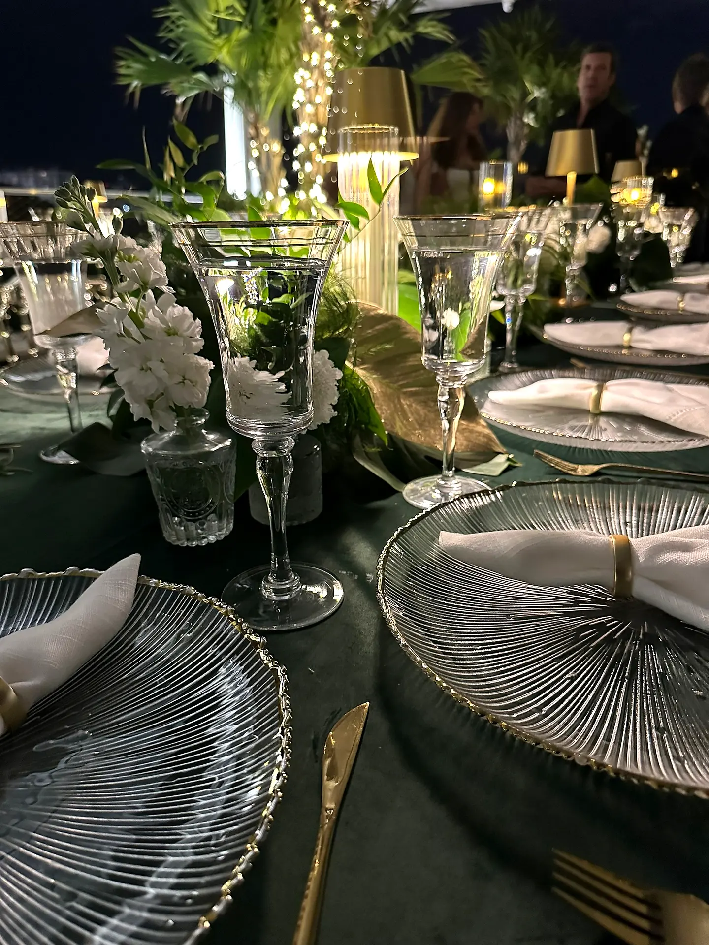 Evening tablescape with gold accents and glass chargers